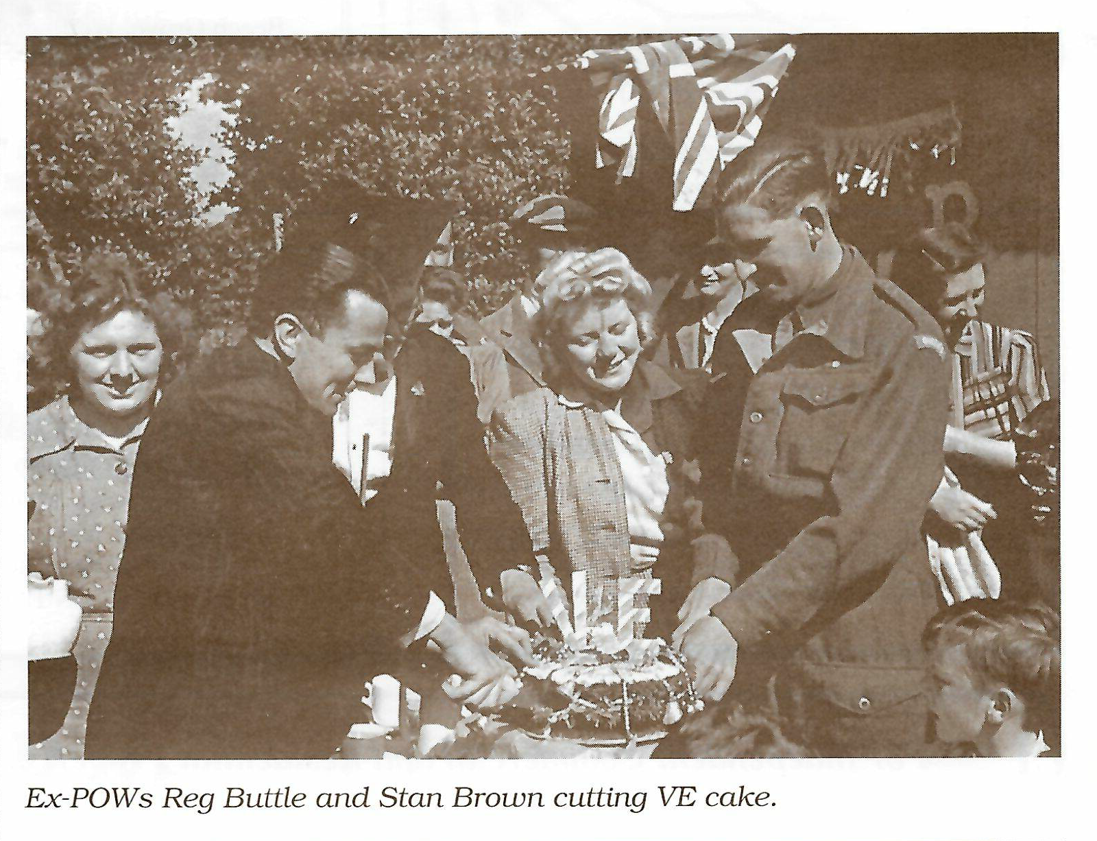 Ex-POWs Reg Buttle and Stan Brown cutting VE cake.