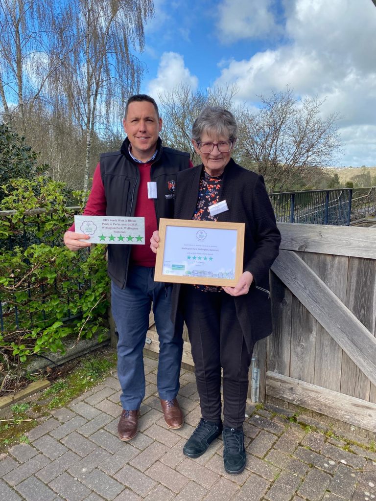 Two people hold up a certificate.