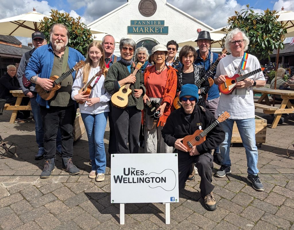 A group of people with ukuleles